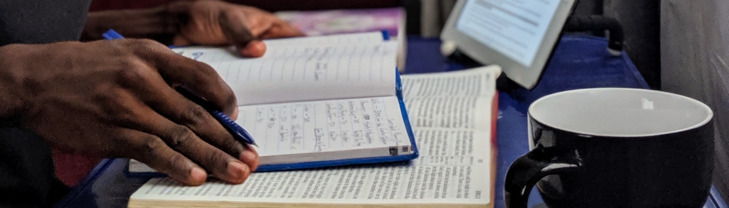 Man reading with tablet nearby