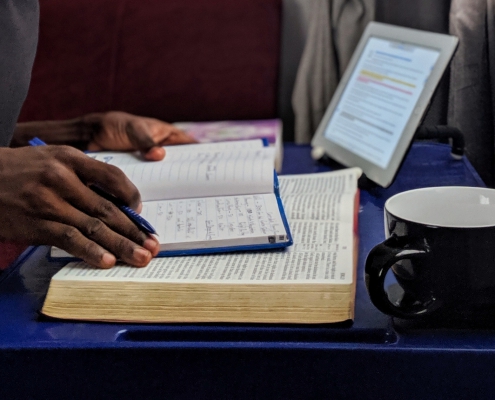 Man reading with tablet nearby