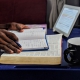 Man reading with tablet nearby