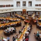 Birdseye view of library filled with people at desks reading
